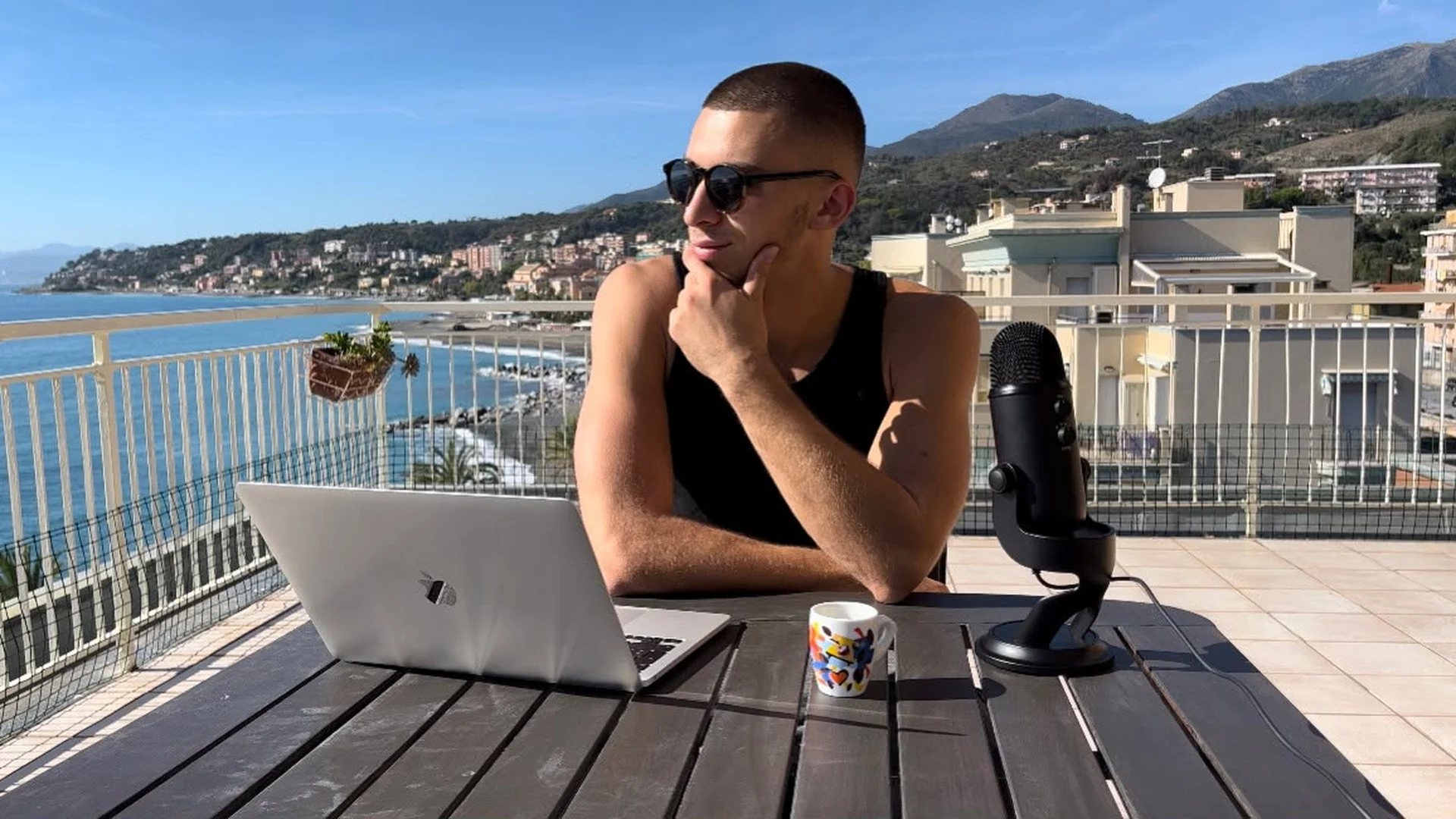 Nick Parodi che opera sui mercati dal terrazzo sul mare